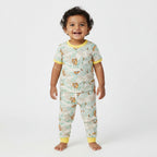 Children's pajama set with animal and leaf pattern on a white background
