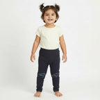 Dark gray leggings with cloud designs on a light gray background