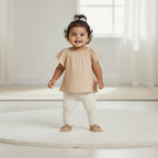 Beige blouse with ruffled sleeves on a beige background