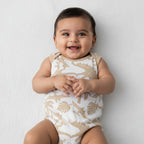Baby romper with dinosaur pattern on a white background