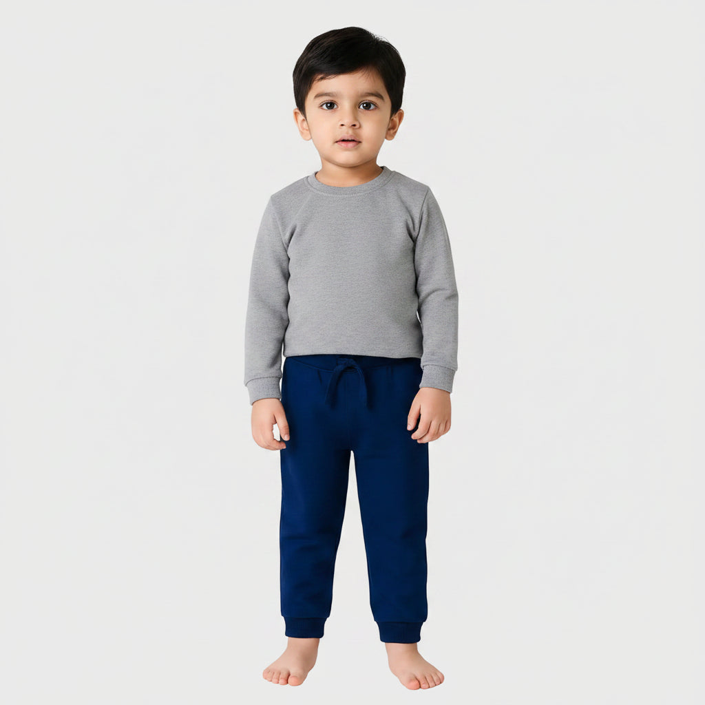 Navy blue jogger pants worn by a child on a white background