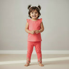 Pink leggings with floral glitter embroidery on a light gray background