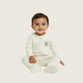 Baby onesie with a teddy bear design on a white background