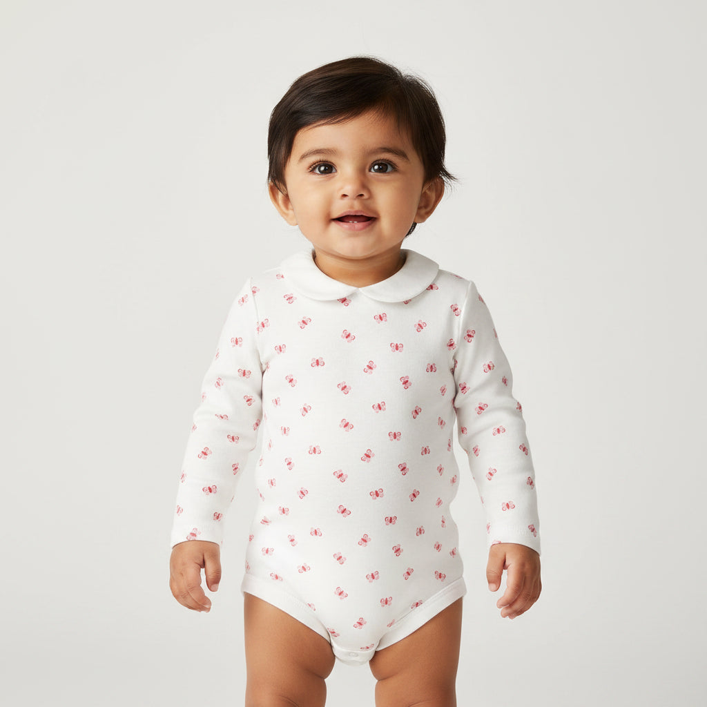 White baby bodysuit with red floral pattern on a white background