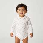 White baby bodysuit with red floral pattern on a white background