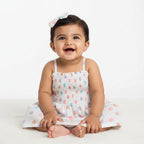 Children's dress with colorful polka dot pattern on a white background