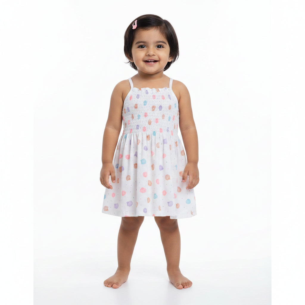 Children's top with colorful polka dot pattern on a white background