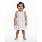 Children's top with colorful polka dot pattern on a white background